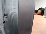 two refrigerators that are sitting in the middle of a room