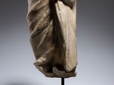 a statue of a woman wrapped in a blanket on top of a wooden stand