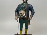 figurine of a man in a top hat and top hat holding a clock