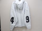 white hoodie with black numbers on it hanging on a wall