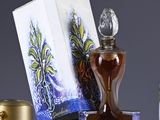 a bottle of perfume sitting on a table next to a box