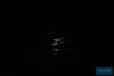 the bird is flying in the dark sky above the water