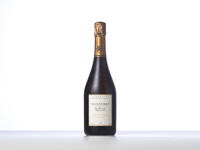 a bottle of wine sitting on top of a white table