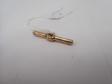an image of a small gold pipe on a white surface