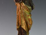 a statue of a woman holding a bird on a pedestal