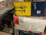 a pile of boxes on top of a shelf in a room