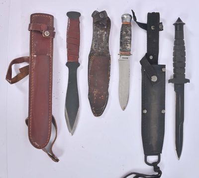 several different types of knives are lined up on a white surface