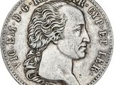 une pièce d'argent représentant la tête d'un homme aux cheveux longs