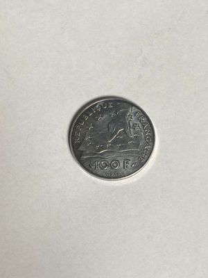 a close up of a coin on a white surface with a white background