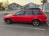 a red car that is parked in a parking lot