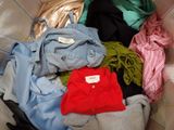 a basket full of clothes that is sitting on the floor