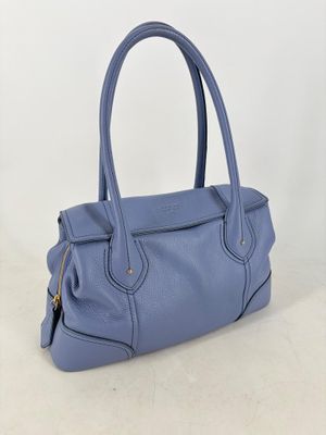 a blue leather handbag on a white background