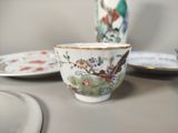 a cup and saucer sitting on a table next to a plate
