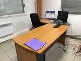 a desk with two computers and a laptop on it