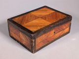 an old wooden box sitting on top of a white surface