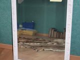 a mirror that is sitting on the floor in a room