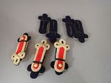 four pairs of black and red skateboards sitting on top of a table