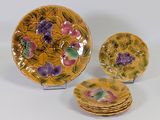 three pieces of yellow and purple plates with flowers on them