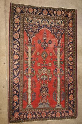 an old rug hanging on a wall in a room