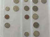 a lot of coins in a plastic tray on the table