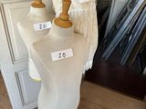 three mannequins on display in a room next to a door