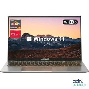 un ordinateur portable affichant Windows 11 à l'écran, avec une montagne en arrière-plan