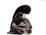 a black and gold helmet with a black pom pom on it