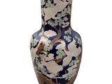 a vase that has a bird on it on a white background