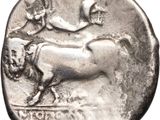 a close up of a silver coin with a bull on it