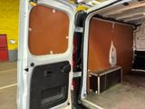 a white van with its door open in a garage