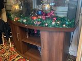 a fish tank with ornaments on it in the corner of a room
