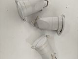 four white cups sitting on top of a white table
