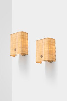pair of bamboo sconces mounted on a wall in a white room