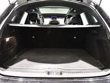 the back of a car with its trunk open and luggage in the trunk