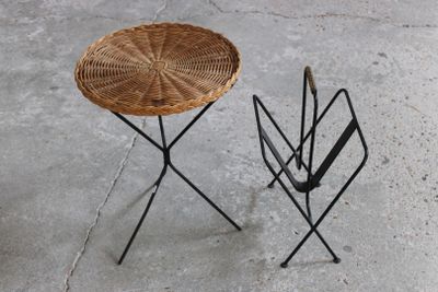 a wicker table and umbrella stand on the concrete floor