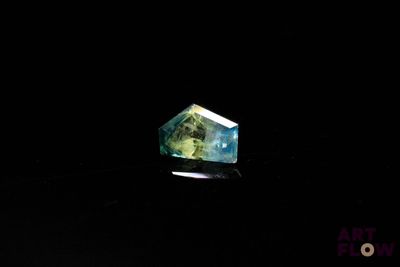 an image of a green and blue diamond in the dark
