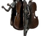 statue of a man and a woman playing a musical instrument on a pedestal