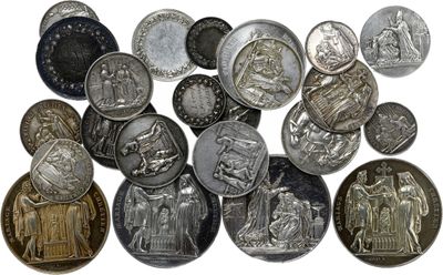 silver and silver coins are arranged on a white surface