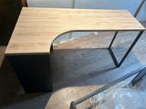 the desk is made of wood and has a metal frame