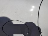 a shadow of a person holding a cell phone in their hand