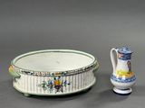two vases and a bowl sitting next to each other on a table