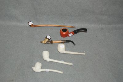 une pipe, un porte-pipe, un porte-pipe et un porte-pipe posé sur une table