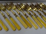 gold plated flatware set with matching knives and spoons