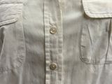 a close up of a white shirt with buttons on it