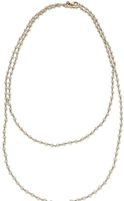 a close up of a necklace with pearls on a white background