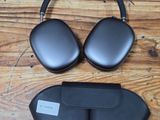 an image of a pair of black headphones on a wooden floor