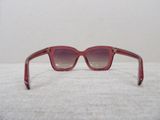 sunglasses on a table with a white wall in the background