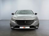 the front view of a silver car in a white room