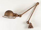 an old brass lamp with a metal shade on a white background