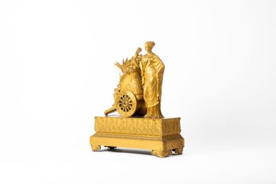a gold statue of a man and a woman on a cart